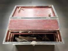 An antique pine joiner's tool chest containing various tools and hardware.
