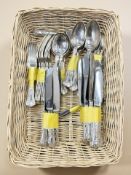 A wicker tray containing EPNS and stainless steel cutlery.