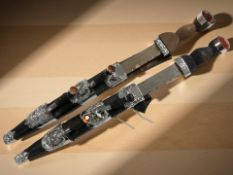 Two ornate reproduction Scottish dirks, in sheathes,