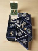 A group of Swarovski crystal Christmas tree decorations, including snowflakes,