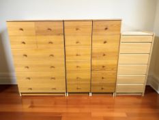 A contemporary Scandinavian pine effect eight drawer chest, 81 cm x 41 cm x 126 cm,