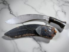 An antique kukri knife, in scabbard.