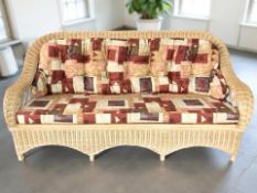A wicker three seater conservatory settee,