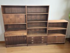 A Scandinavian teak three section open bookcase fitted with cupboards and drawers,