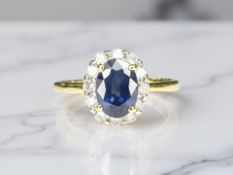 An 18ct gold sapphire and diamond cluster ring, size K½. CONDITION REPORT: 2.