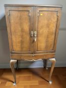 A reproduction walnut double door drinks cabinet, 80 cm x 43 cm x 147 cm.