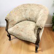 An early 20th century tub armchair in floral upholstery, width 72 cm.
