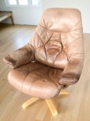 A Scandinavian bentwood and faded tan leather swivel armchair