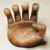 A hardwood carved sculpture modelled as a hand, height 49 cm.