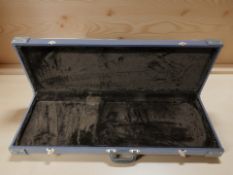 A hard shell electric guitar travel case.