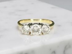 An 18ct gold three-stone diamond ring, the central stone approximately 0.70 carat, size U½.