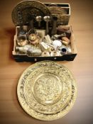 A group of engraved brass vases, enameled metal wares, a brass magazine rack, several chargers,