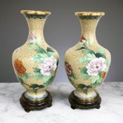 A pair of 20th century Chinese cloisonne baluster vases, on turned wooden stands,