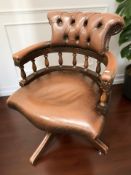 A brown leather Chesterfield-style buttoned swivel office chair, width 65 cm.
