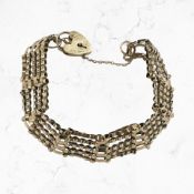 A 9ct yellow gold gate bracelet with padlock clasp and safety chain.
