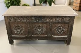 A George III carved oak coffer, 131 cm x 55 cm x 66 cm.