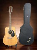A Farida twelve string acoustic guitar, with hard carry case and a guitar stand.