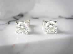A pair of diamond solitaire ear studs, the brilliant-cut stones weighing an estimated 1.