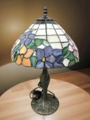 A Tiffany-style patinated metal and stained glass mushroom table lamp, height 49 cm.