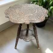 A late 19th century Anglo-Indian heavily carved hardwood tripod occasional table, height 54 cm.