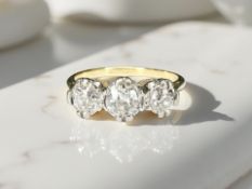 An 18ct gold three-stone diamond ring, approximately 0.