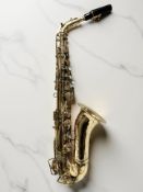 A vintage brass alto saxophone, apparently unmarked.