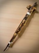 Three decorative reproduction carved wooden walking sticks.