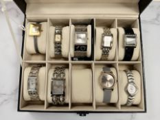 A watch display box containing nine Lady's dress watches, Guess, Armani, Sekonda etc.