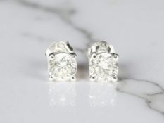 A pair of 18ct white gold diamond stud earrings, the brilliant-cut stones weighing an estimated 0.