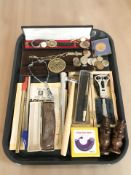 A group of watchmaker's tools, a ring sizer, various coins, wristwatches, a harmonica,