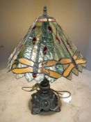 A Tiffany-style patinated metal and stained glass dragonfly table lamp, height 55 cm.
