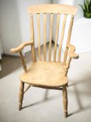 A pine farmhouse style armchair, width 62 cm.