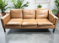 A Scandinavian tan leather three seater settee,