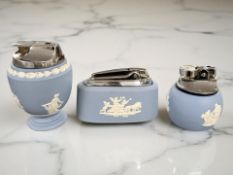 Three Wedgwood blue and white Jasperware table lighters.