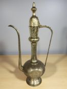 A large engraved brass Islamic coffee pot, height 77 cm.