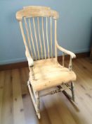 A pine farmhouse rocking chair, width 57 cm.
