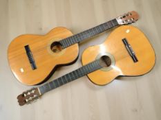 A Spanish classical guitar, plus another similar.