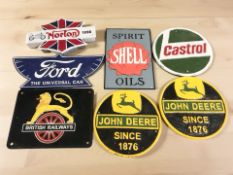 A group of reproduction painted cast iron signs and plaques including Ford, Norton, Castrol, etc,