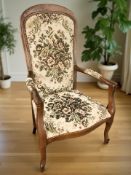 A reproduction continental high back armchair in embroidered upholstery