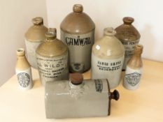 A group of Victorian flagons and beer bottles including cider by Camwal, Timothy White bed warmer,