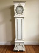 A continental long case clock with pendulum and two weights