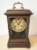 An early 20th century beech eight day mantel clock, with pendulum and keys,