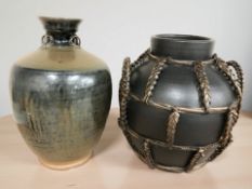 Two earthenware vessels, one bound in wicker, tallest 38 cm high.