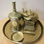 An eastern engraved brass charger, together with a lamp base, tea pot, ink well,