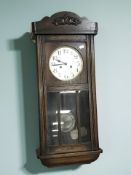 An early 20th century oak eight day wall clock, height 83 cm.
