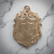A 9ct yellow gold shield shaped fob medal, 30 mm x 20 mm. CONDITION REPORT: 2.5g.