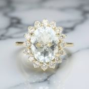 An 18ct gold aquamarine and diamond cluster ring,
