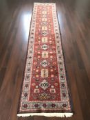 A Causcasian geometric design runner,