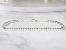 An 18ct white gold diamond tennis bracelet, the total diamond weight estimated at 2.