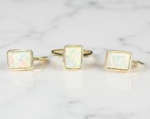 A 14ct yellow gold opal ring, size N, together with the matching pair of earrings.